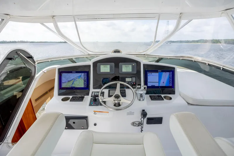 Slide: The Image of Helm of 2008 Hatteras 64 Motor Yacht with navigation screens and steering wheel. - 80