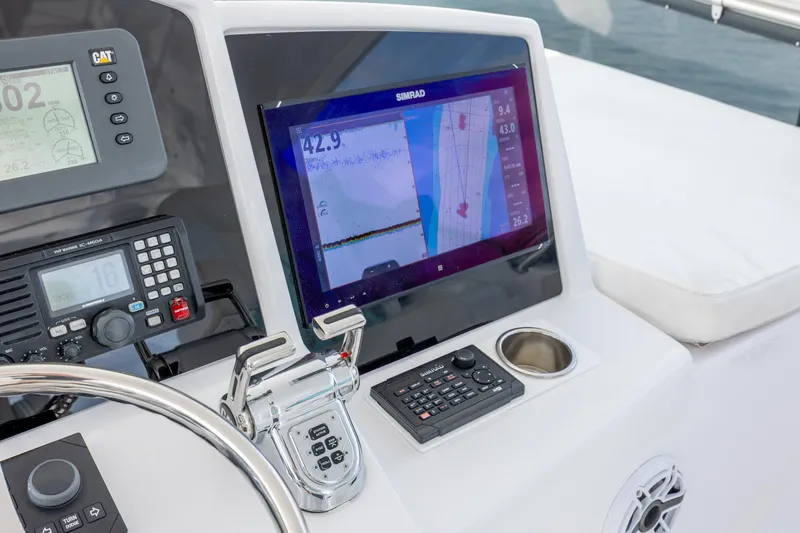 Slide: The Image of Control panel of a 2008 Hatteras 64 Motor Yacht with navigation and communication equipment. - 82