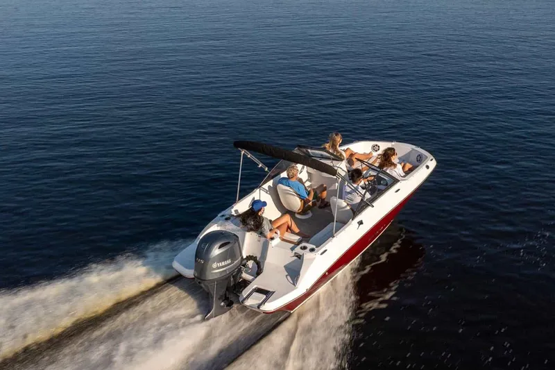 Slide: The Image of Stingray 191 DC 2026 boat cruising on open water with passengers. - 13