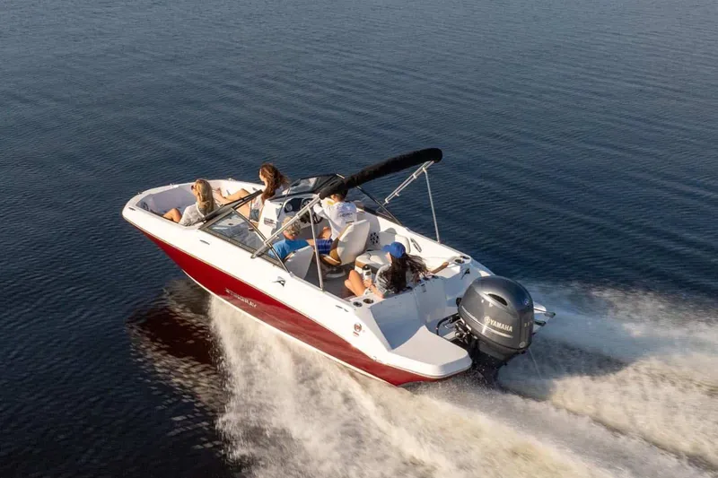 Slide: The Image of 2026 Stingray 191 DC boat cruising on calm water. - 16