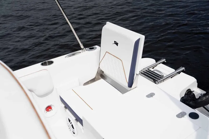 Slide: The Image of 2026 Stingray 173 CC boat with white seat by the water. - 8