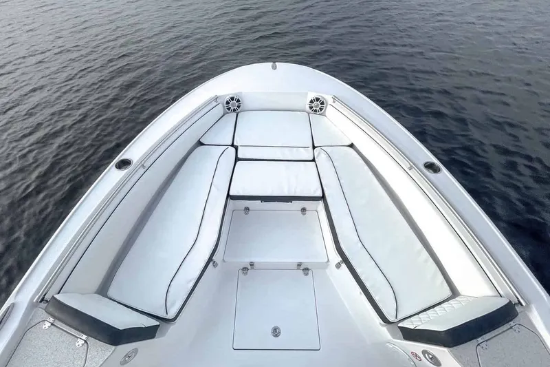 Slide: The Image of 2026 Stingray 236 CC boat with luxurious bow seating on calm water. - 14