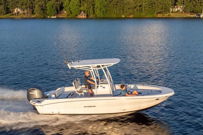 Slide: The Image of 2026 Stingray 236 CC boat cruising on a serene lake. - 17