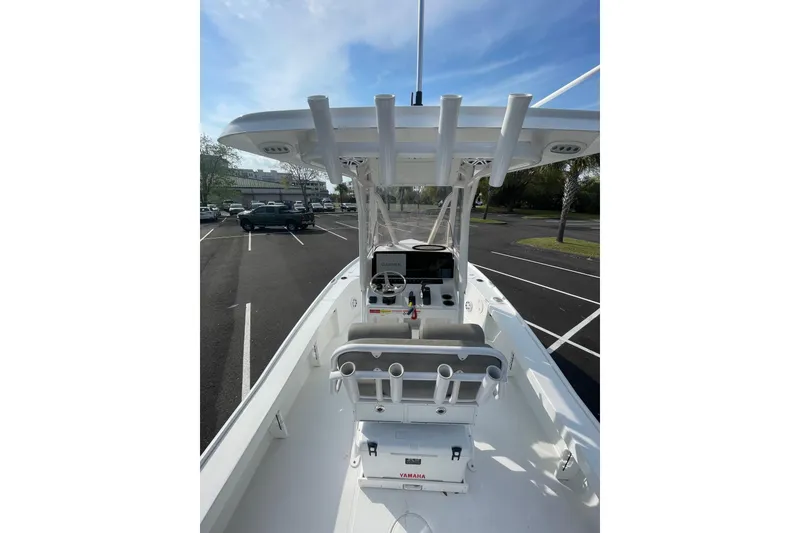 Slide: The Image of 2025 Sea Hunt BX 22 BR boat interior with console and seating in a parking lot. - 15