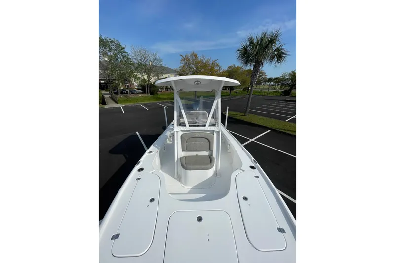 Slide: The Image of 2025 Sea Hunt BX 22 BR boat in a parking lot, featuring sleek white design. - 16