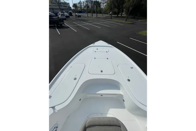 Slide: The Image of 2025 Sea Hunt BX 22 BR boat deck in a parking lot, showcasing storage compartments. - 17