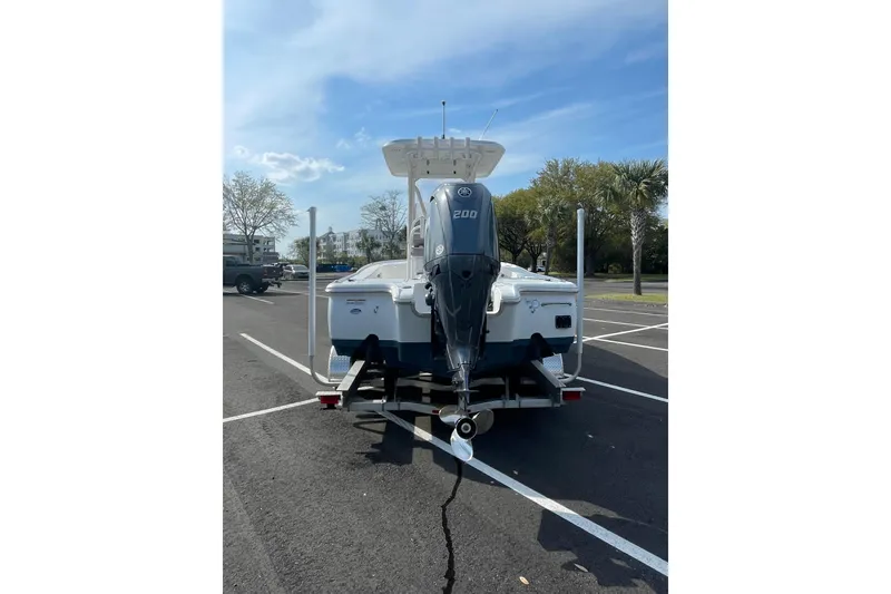 Slide: The Image of 2025 Sea Hunt BX 22 BR boat with 200 HP engine in parking lot. - 3