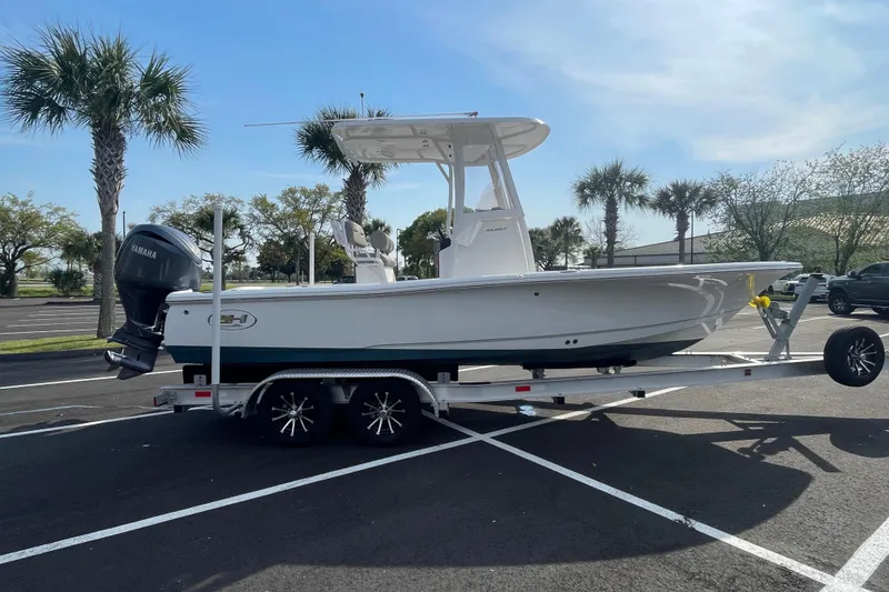 Slide: The Image of 2025 Sea Hunt BX 22 BR boat on trailer in sunny parking lot. - 5