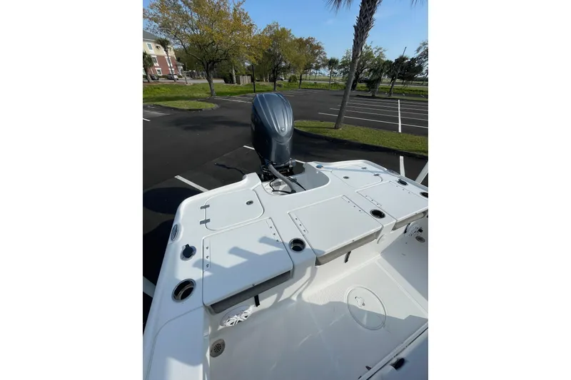 Slide: The Image of 2025 Sea Hunt BX 22 BR boat with outboard motor in parking lot. - 7