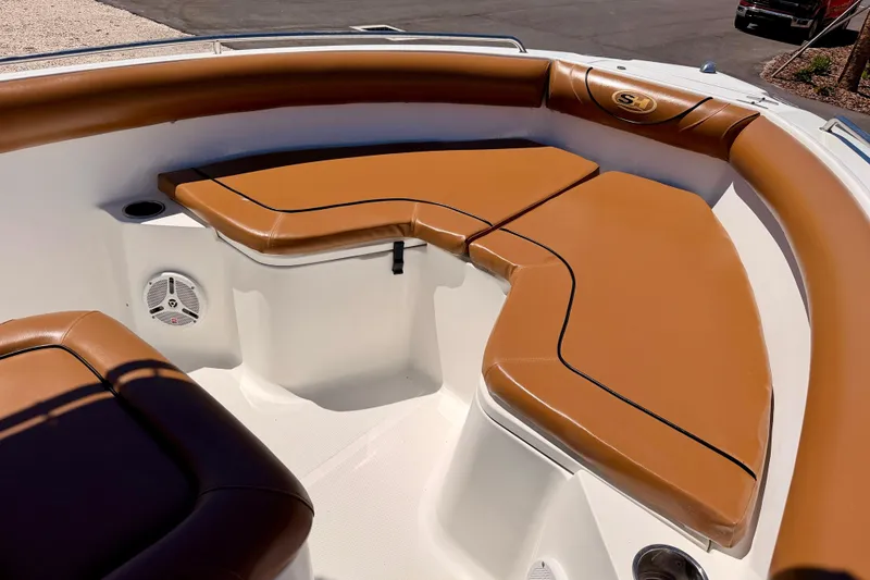 Slide: The Image of Bow seating area of a 2010 Sea Hunt Ultra 210 boat with tan cushions. - 10