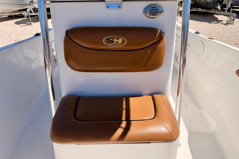 Slide: The Image of Brown cushioned seat on 2010 Sea Hunt Ultra 210 boat, featuring SH logo. - 13