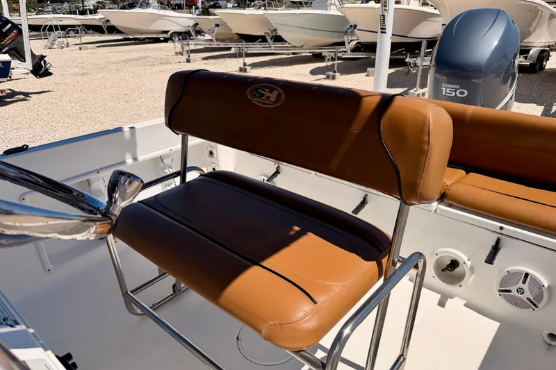 Slide: The Image of 2010 Sea Hunt Ultra 210 boat interior with tan seating and Yamaha 150 engine. - 14