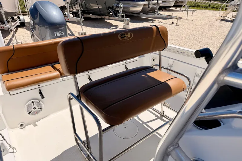 Slide: The Image of 2010 Sea Hunt Ultra 210 boat interior with brown seating and Yamaha 150 engine. - 16