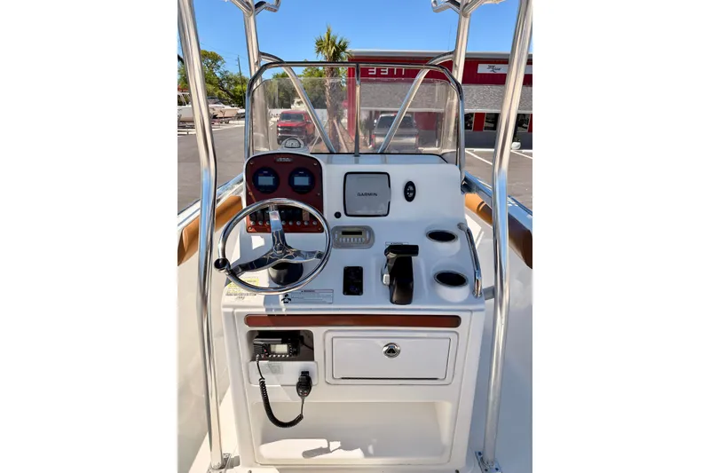 Slide: The Image of 2010 Sea Hunt Ultra 210 boat console with steering wheel and Garmin navigation system. - 17