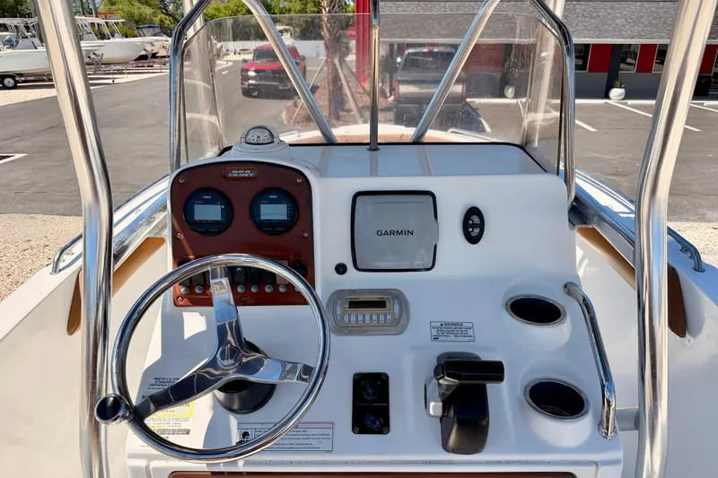 Slide: The Image of 2010 Sea Hunt Ultra 210 boat dashboard with Garmin navigation and steering wheel. - 18