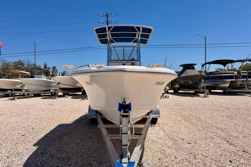 Slide: The Image of 2010 Sea Hunt Ultra 210 boat on trailer in a sunny outdoor lot. - 2