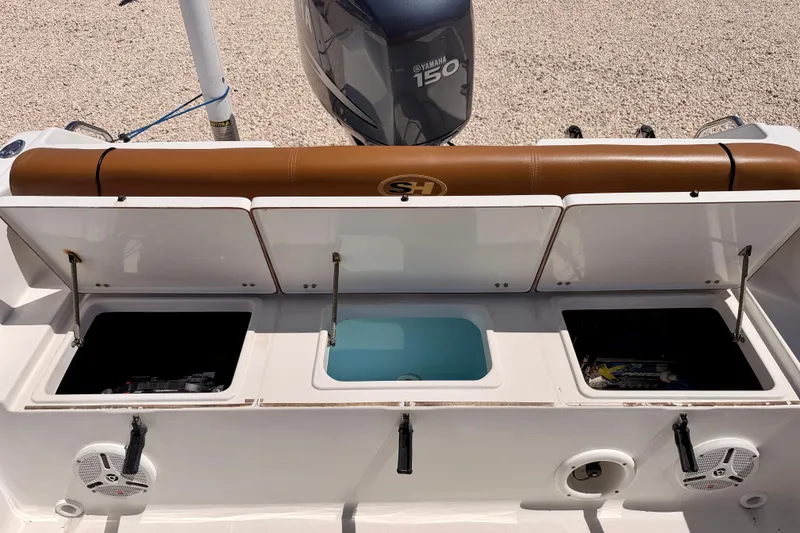 Slide: The Image of 2010 Sea Hunt Ultra 210 boat storage compartments and Yamaha 150 engine. - 22