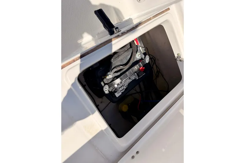 Slide: The Image of Battery compartment of a 2010 Sea Hunt Ultra 210 boat, showing wiring and connections. - 23