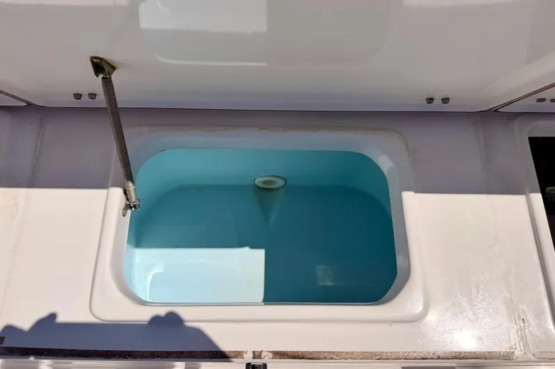 Slide: The Image of Livewell compartment on a 2010 Sea Hunt Ultra 210 boat, open and filled with water. - 25