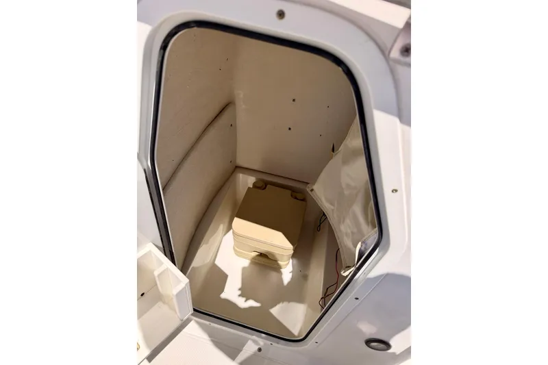 Slide: The Image of Interior view of 2010 Sea Hunt Ultra 210 boat compartment with portable toilet. - 26