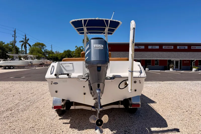 Slide: The Image of 2010 Sea Hunt Ultra 210 boat with Yamaha 150 engine, parked outdoors. - 6