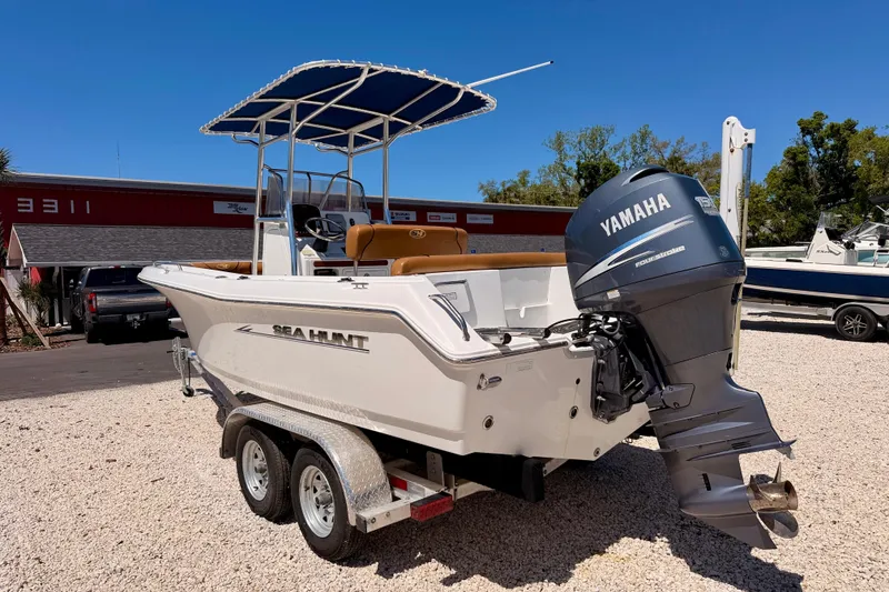 Slide: The Image of 2010 Sea Hunt Ultra 210 boat with Yamaha engine on trailer, parked outdoors. - 7
