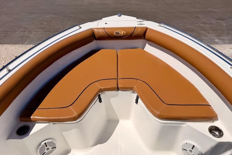 Slide: The Image of 2010 Sea Hunt Ultra 210 boat with tan cushioned seating in the bow area. - 9