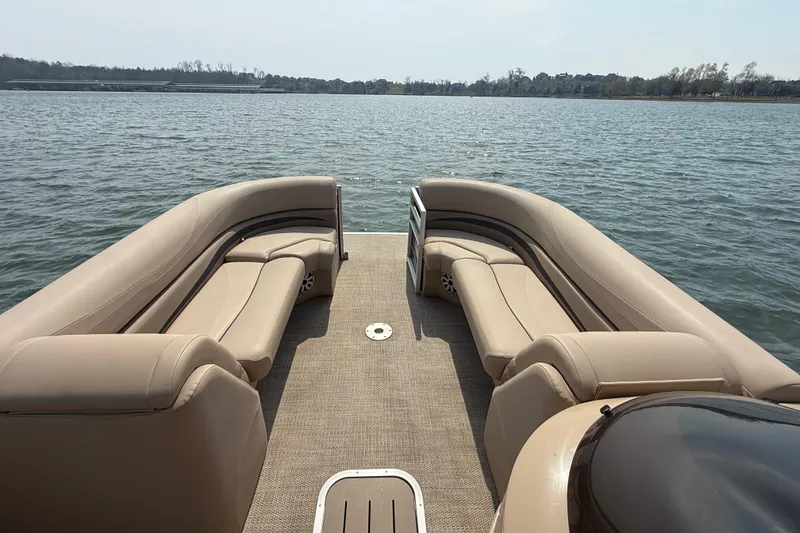 Slide: The Image of 2018 Bennington 23GSRFB pontoon boat with beige seating on a calm lake. - 10