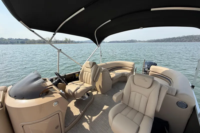Slide: The Image of 2018 Bennington 23GSRFB pontoon boat interior with beige seating on a lake. - 13