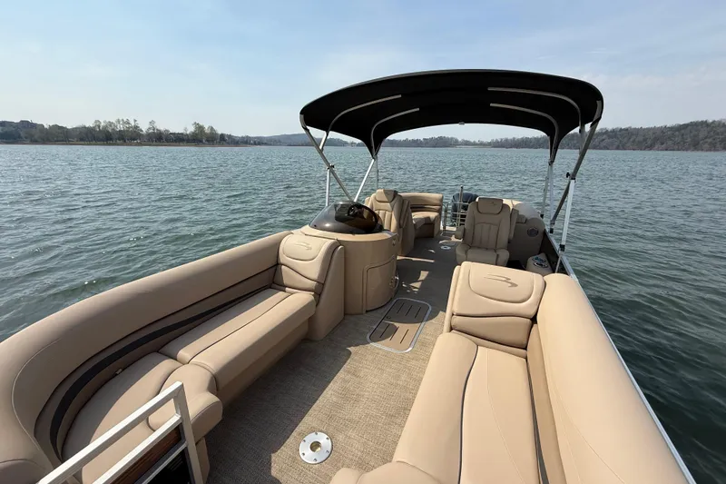 Slide: The Image of 2018 Bennington 23GSRFB pontoon boat with beige seating on a calm lake. - 14