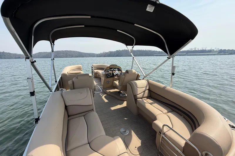 Slide: The Image of 2018 Bennington 23GSRFB pontoon boat with beige seating on a calm lake. - 15