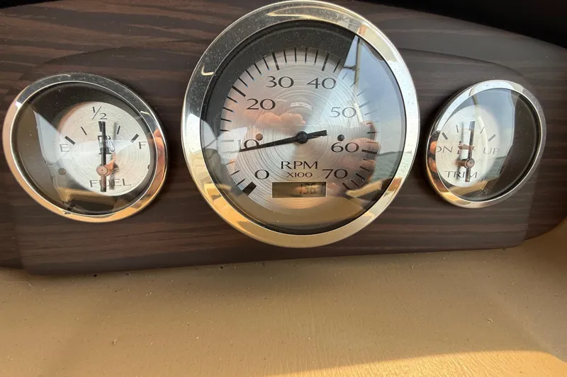 Slide: The Image of Dashboard gauges of a 2018 Bennington 23GSRFB boat, showing RPM, fuel, and trim levels. - 16