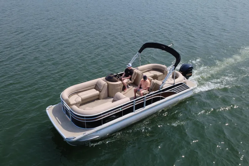 Slide: The Image of 2018 Bennington 23GSRFB pontoon boat cruising on open water. - 2