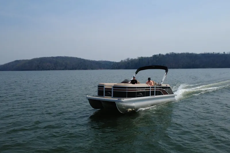 Slide: The Image of 2018 Bennington 23GSRFB pontoon boat cruising on a scenic lake. - 4