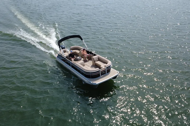 Slide: The Image of 2018 Bennington 23GSRFB pontoon boat cruising on open water. - 5