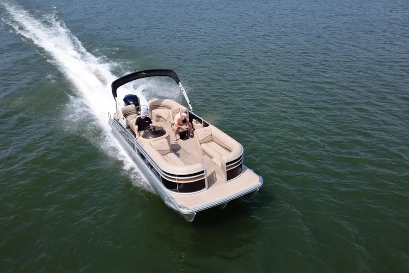 Slide: The Image of 2018 Bennington 23GSRFB pontoon boat cruising on open water. - 6