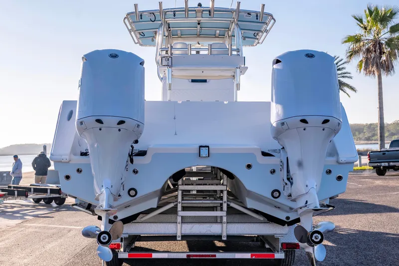 Slide: The Image of Rear view of a 2011 Freeman 33 boat with dual outboard motors. - 10