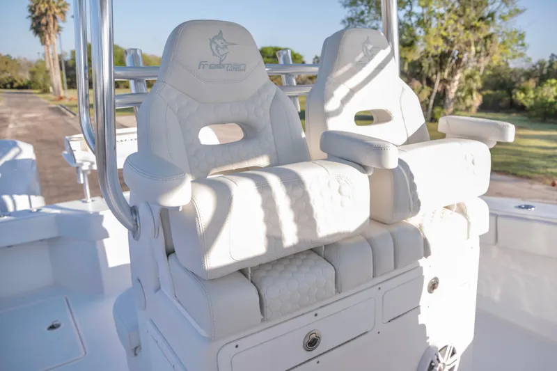 Slide: The Image of White leather seats on a 2011 Freeman 33 boat, featuring sleek design and comfort. - 14