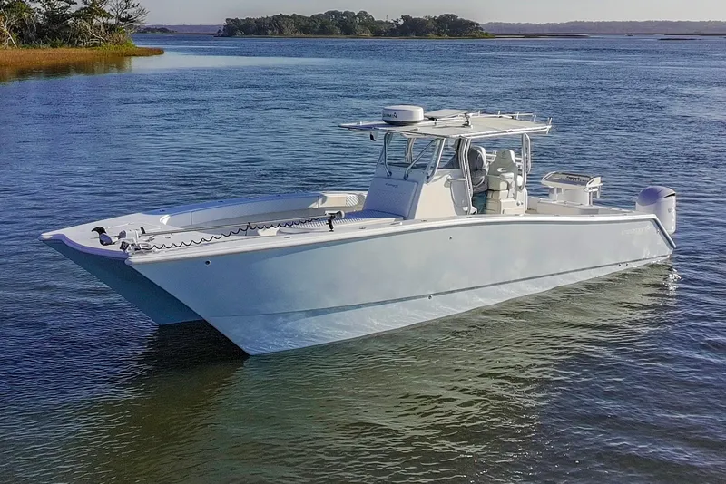 Slide: The Image of 2011 Freeman 33 boat on calm water, featuring sleek design and modern equipment. - 3