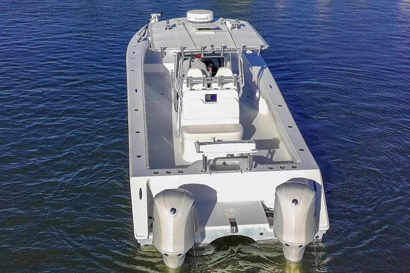 Slide: The Image of Freeman 33 boat, 2011 model, with dual outboard motors on calm water. - 4