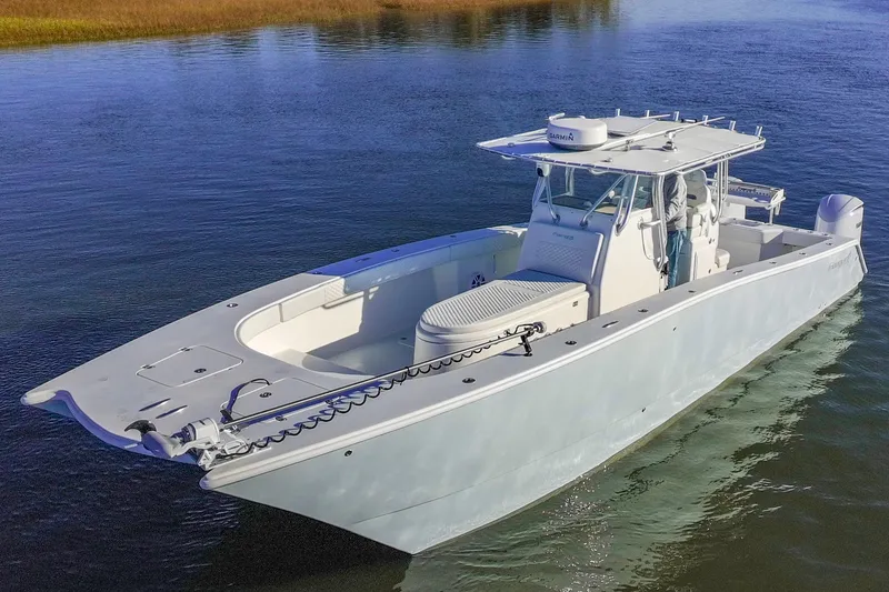 Slide: The Image of Freeman 33 boat from 2011 on calm water, showcasing sleek design and spacious deck. - 5