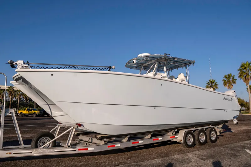 Slide: The Image of 2011 Freeman 33 boat on trailer under clear blue sky. - 7