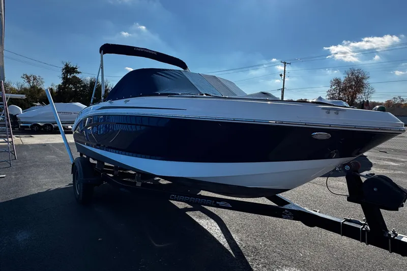 Slide: The Image of 2015 Chaparral 19 H2O Sport boat on trailer under clear blue sky. - 13