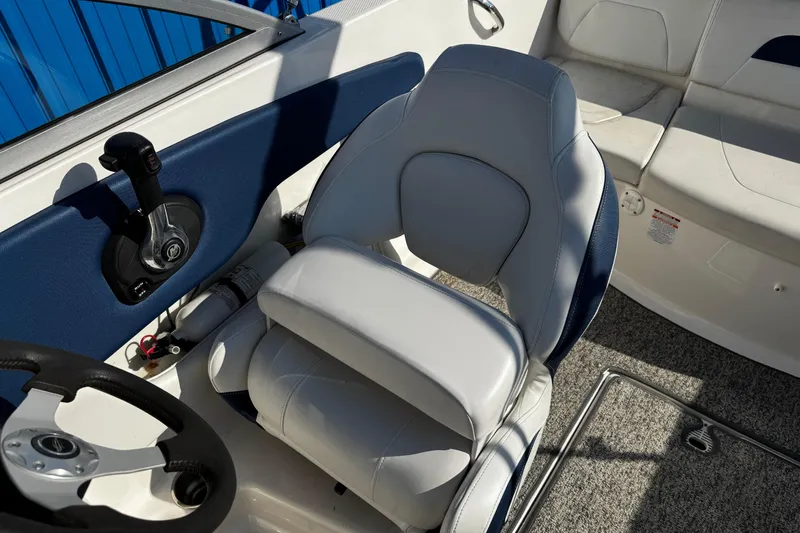 Slide: The Image of 2015 Chaparral 19 H2O Sport boat interior with steering wheel and captain's seat. - 16