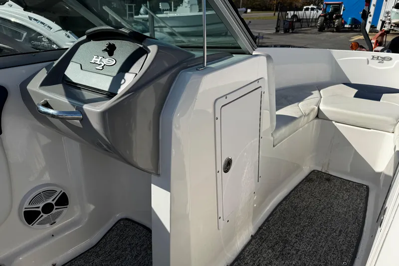 Slide: The Image of Interior view of a 2015 Chaparral 19 H2O Sport boat, featuring seating and dashboard. - 22