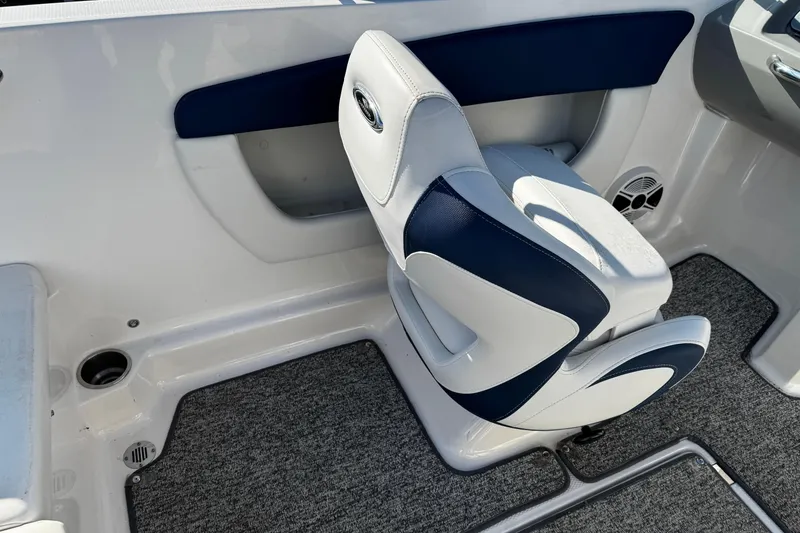 Slide: The Image of Interior of 2015 Chaparral 19 H2O Sport boat with cushioned seating and carpeted flooring. - 30
