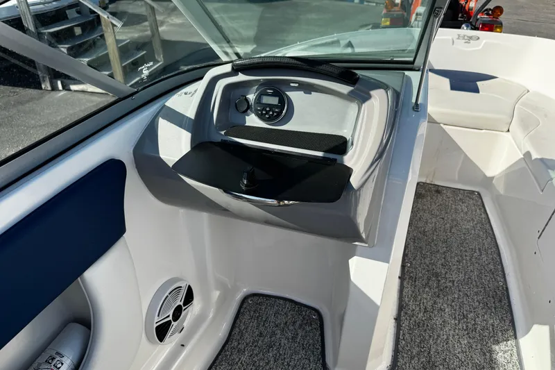 Slide: The Image of 2015 Chaparral 19 H2O Sport boat interior with dashboard and seating area. - 32