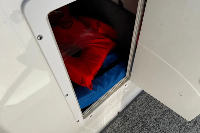Slide: The Image of Storage compartment with life jackets in a 2015 Chaparral 19 H2O Sport boat. - 36