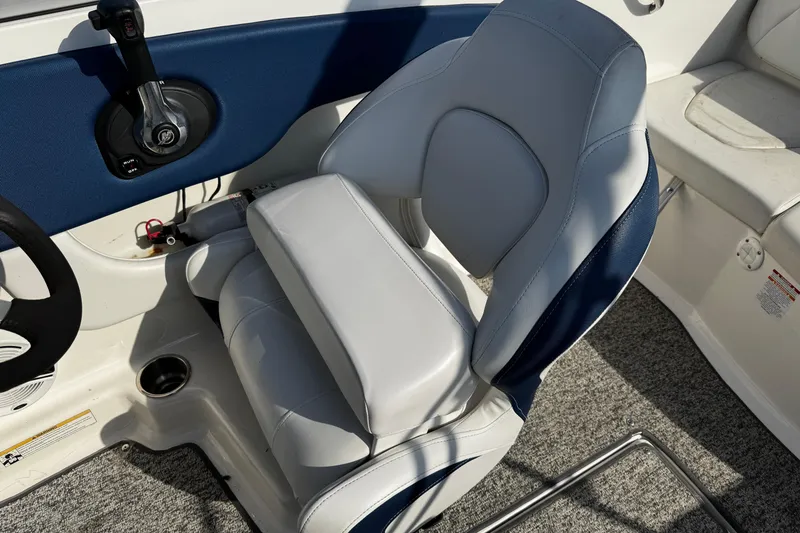 Slide: The Image of Captain's seat in 2015 Chaparral 19 H2O Sport boat, featuring blue and gray upholstery. - 42