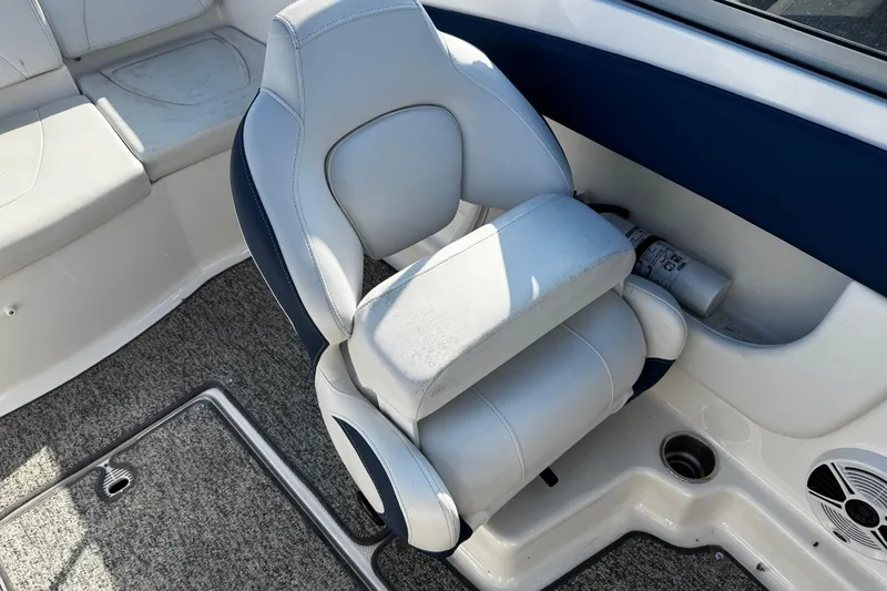 Slide: The Image of 2015 Chaparral 19 H2O Sport boat interior with cushioned seating and carpeted flooring. - 43